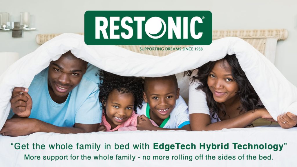 Family under a blanket on a Restonic bed